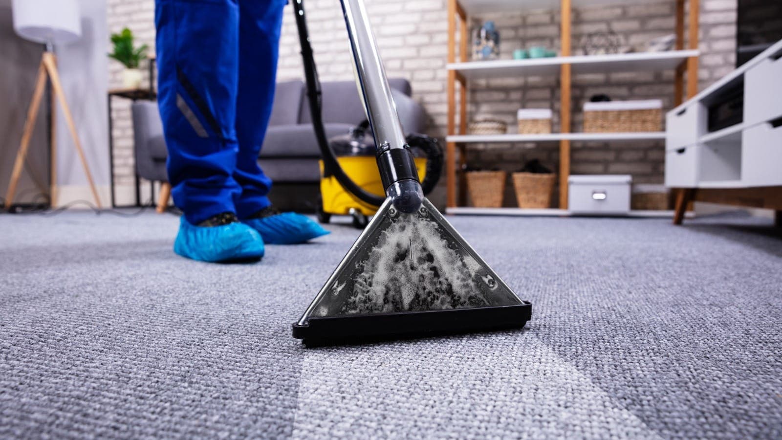 Carpet extractor wand cleaning a light grey residential carpet