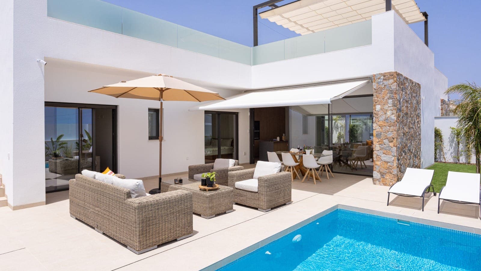 Modern Kiwi holiday rental exterior with outdoor furniture and a pool