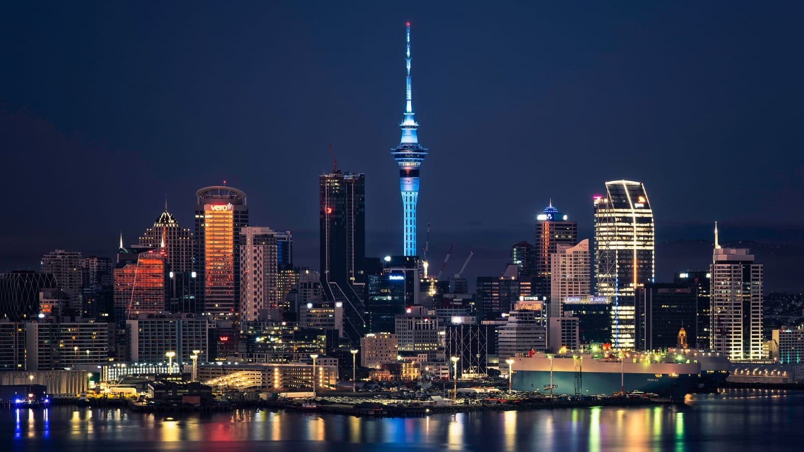 Auckland CBD skyline at night with the Sky Tower lit blue